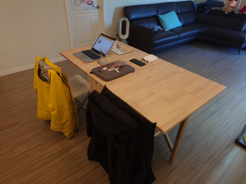A photo of the IKEA NORDEN table, with two chairs and a laptop on top.